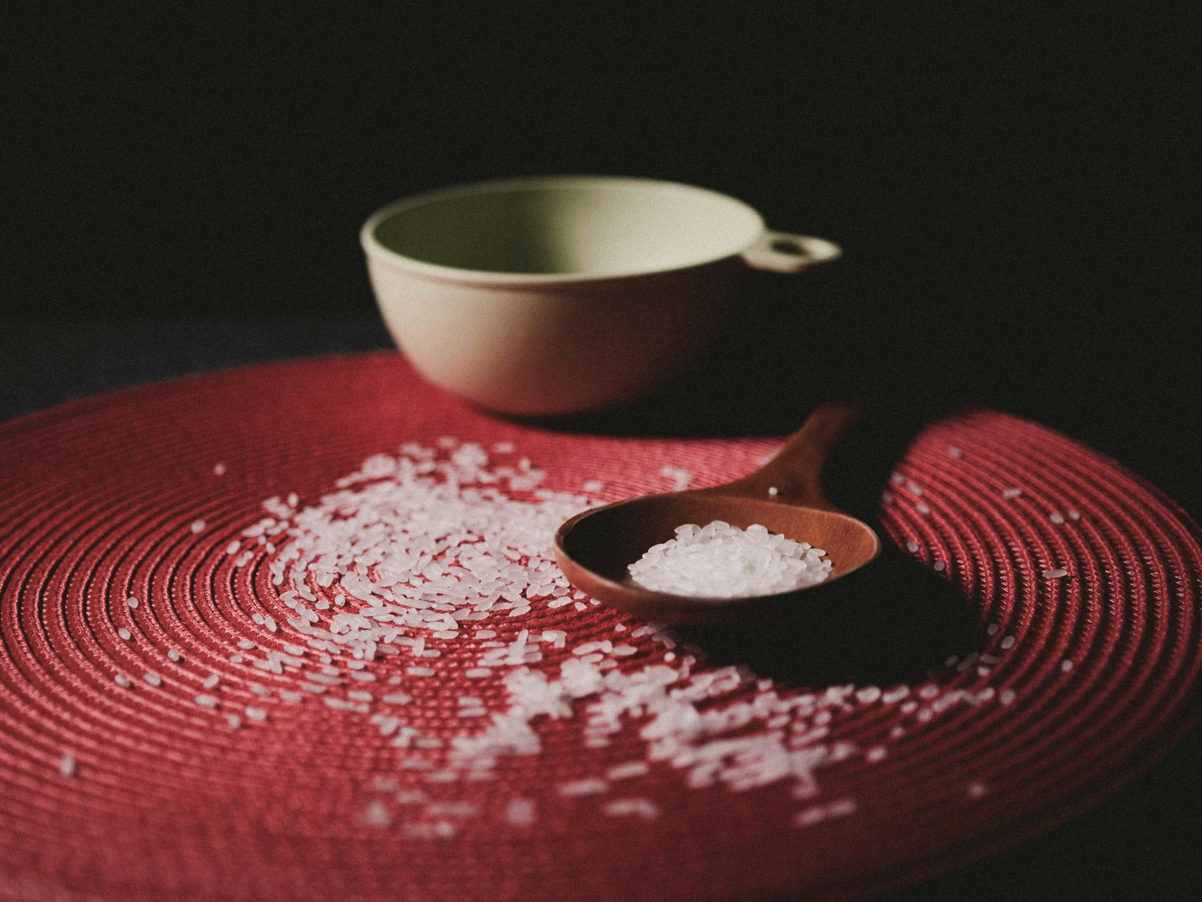 brown wooden spoon with grains on red table cloth