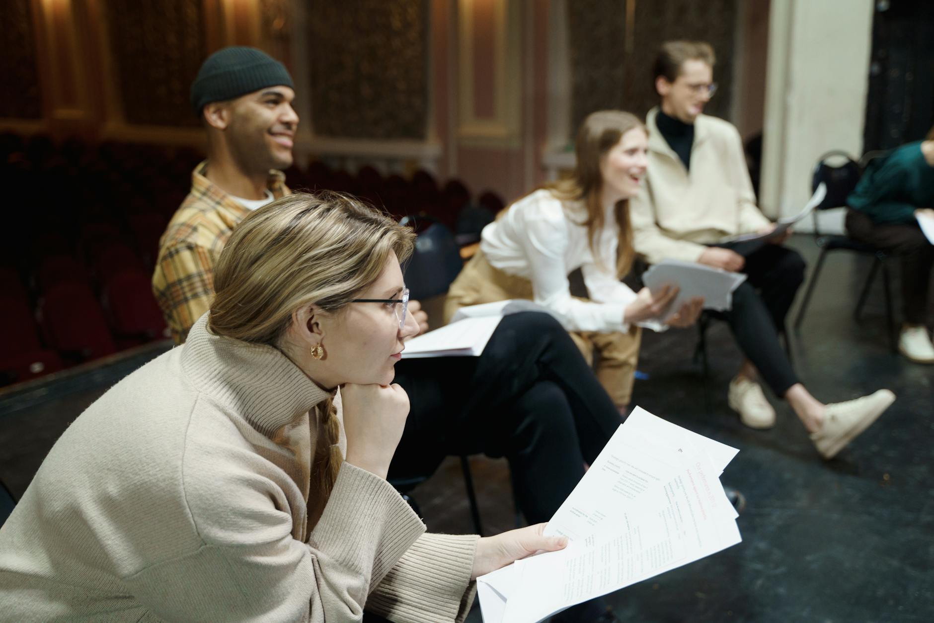 group of people sitting with their scripts